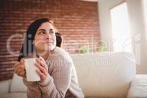 Young woman looking away at home