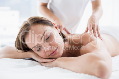 Woman receiving back massage from masseur