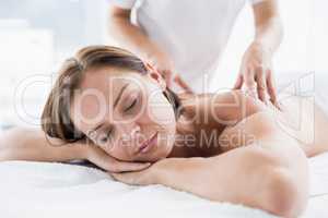 Woman receiving back massage from masseur