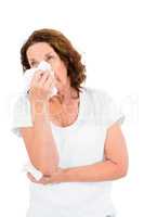 Mature woman sneezing while standing