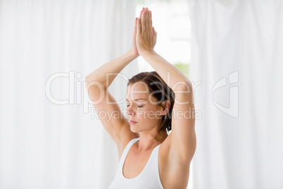 Woman with eyes closed doing yoga