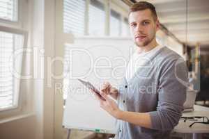 Businessman with digital tablet while giving presentation in off