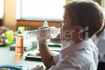 Close-up of schoolboy drinking water