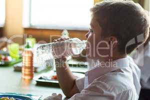 Close-up of schoolboy drinking water