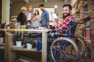 Portrait of disabled businessman using digital tablet