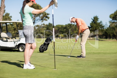 Couple playing golf together