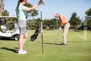 Couple playing golf together