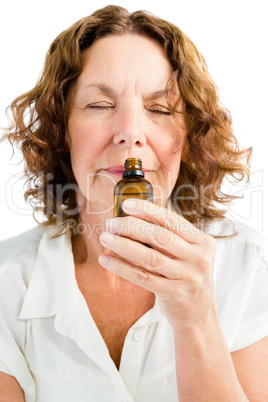 Close-up of mature woman smelling medicine