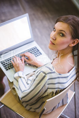 Portrait of confident executive with laptop at office