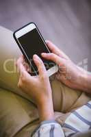 Midsection of businesswoman using cellphone at office