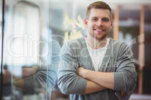 Portrait of businessman with arms crossed in office