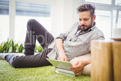 Businessman working on laptop while reclining in office