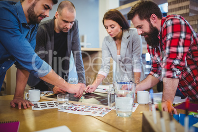 Creative colleagues drawing on blackboard during meeting