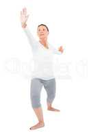 Mature woman with arms outstretched while exercising