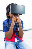 Boy using virtual reality headset in classroom