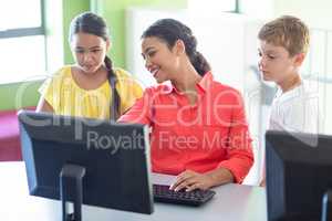 Teacher with children in computer class