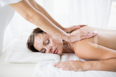 Masseur giving back massage to woman
