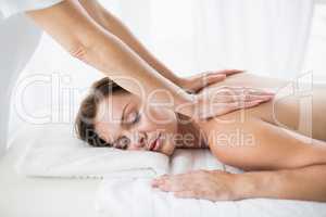 Masseur giving back massage to woman