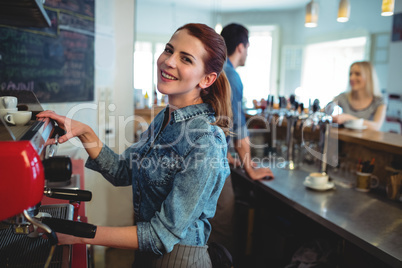 Portrait of happy waitress with co-worker talking to customer at