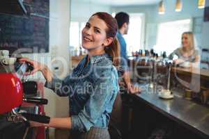 Portrait of happy waitress with co-worker talking to customer at