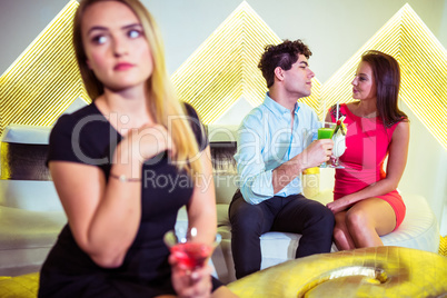 Woman sitting by couple