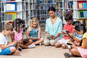 Teacher with children using digital tablet