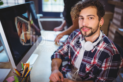 Creative businessman sitting at computer desk in office