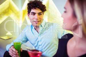 Couple enjoying cocktail in nightclub