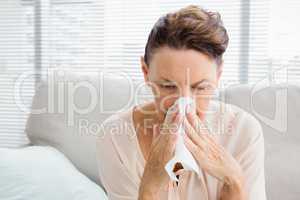 Mature woman with blowing nose
