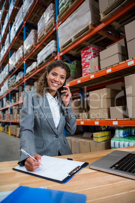 Business woman calling on her desk