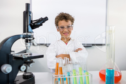 Portrait of boy standing table at laboratory