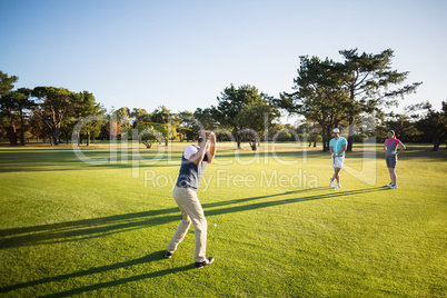 Full length of people playing golf