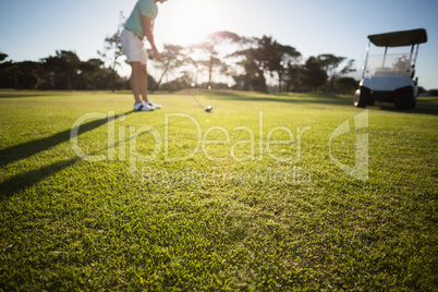 Male golfer standing on field