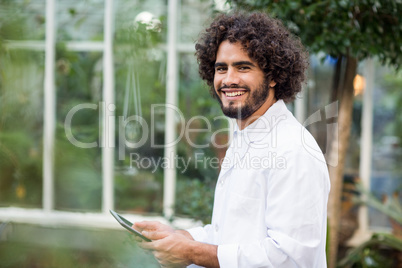 Portrait of male scientist using digital tablet