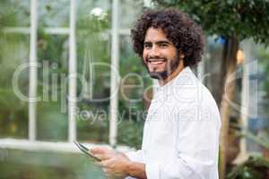 Portrait of male scientist using digital tablet
