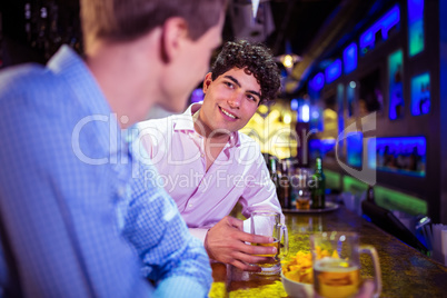 Friends talking at bar counter