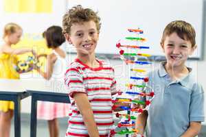 Cheerful boys holding DNA model