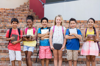 Students holding digital tablets