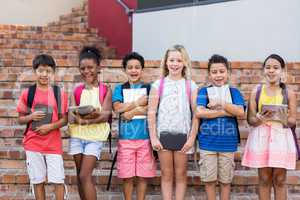 Students holding digital tablets