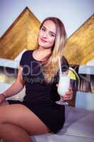 Portrait of woman enjoying drink in nightclub