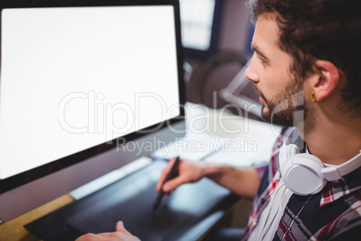 Graphic designer looking at computer monitor while working
