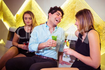 Sad woman sitting by happy couple