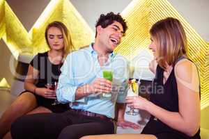 Sad woman sitting by happy couple