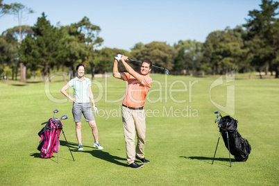 Happy golfer taking shot