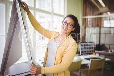 Portrait of businesswoman giving presentation in creative office