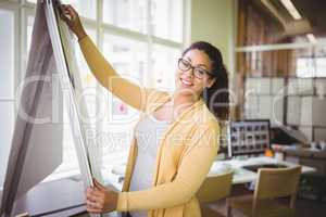 Portrait of businesswoman giving presentation in creative office