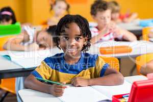 Smiling boy with book on bench