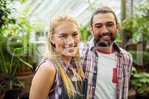 Portrait of happy gardeners at greenhouse