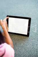 Girl using digital tablet in school library