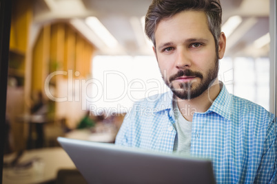 Portrait of businessman using digital tablet in office Portrait of businessman using digital tablet in office